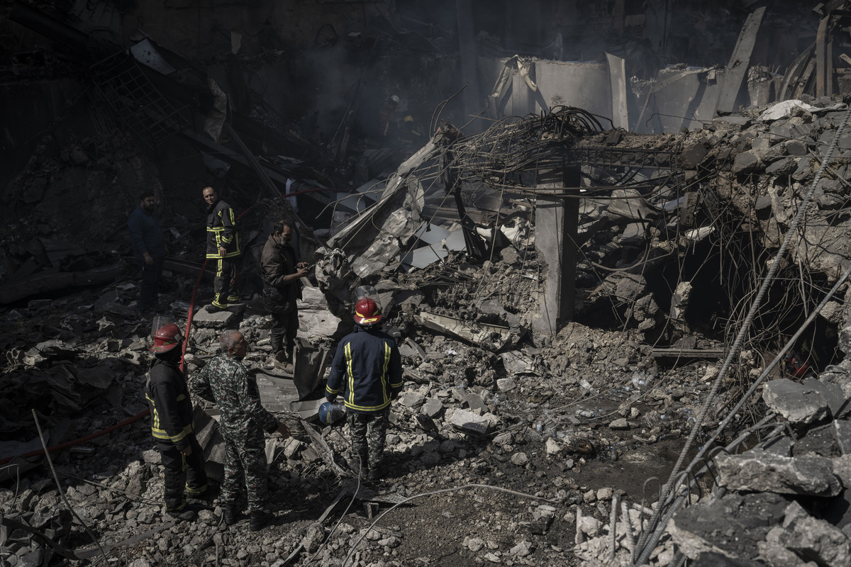 Civilians inspect the site as a residential building lies in ruins and surrounding structures show heavy damage after an Israeli strike hits Corniche Al-Mazraa district in Beirut, Lebanon on April 09, 2026. [Murat Şengül - Anadolu Agency]