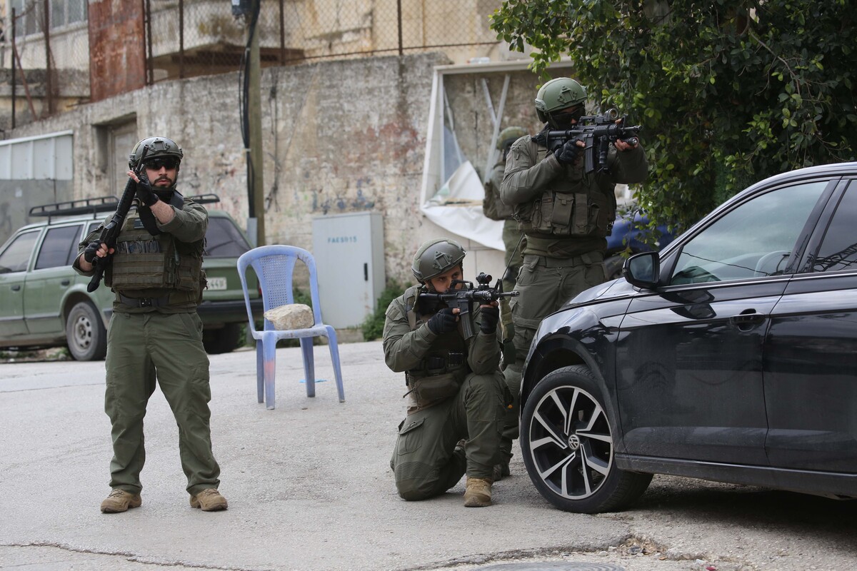 Israeli soldiers aim their weapons while standing on a street during an Israeli army raid in the northern West Bank city of Nablus, in Nablus, West Bank, Palestine on April 12, 2026. [Nedal Eshtayah - Anadolu Agency]