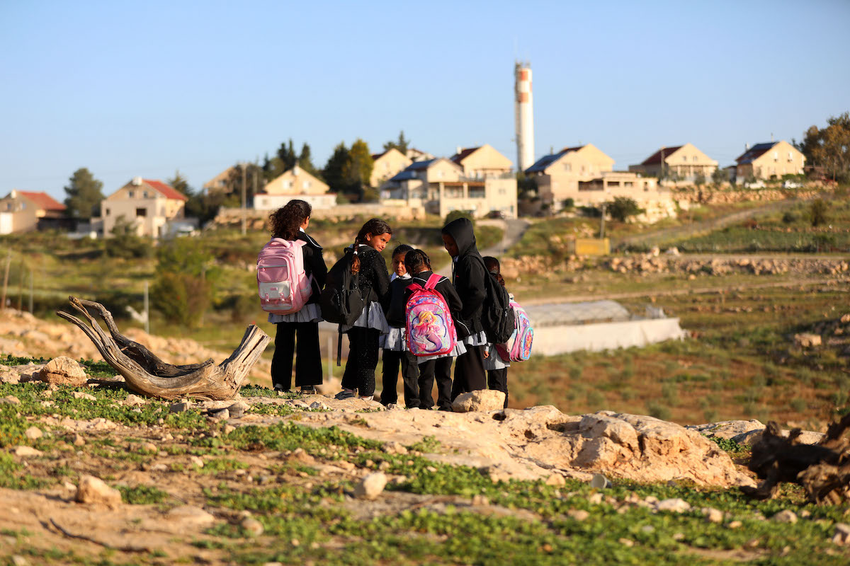 Palestinian students attend an outdoor lesson in the street after Israeli settlers blocked the road leading to their school in the village of Ummul Khayr, located in the Masafer Yatta region south of Hebron, West Bank on April 14, 2026. [Wisam Hashlamoun - Anadolu Agency]