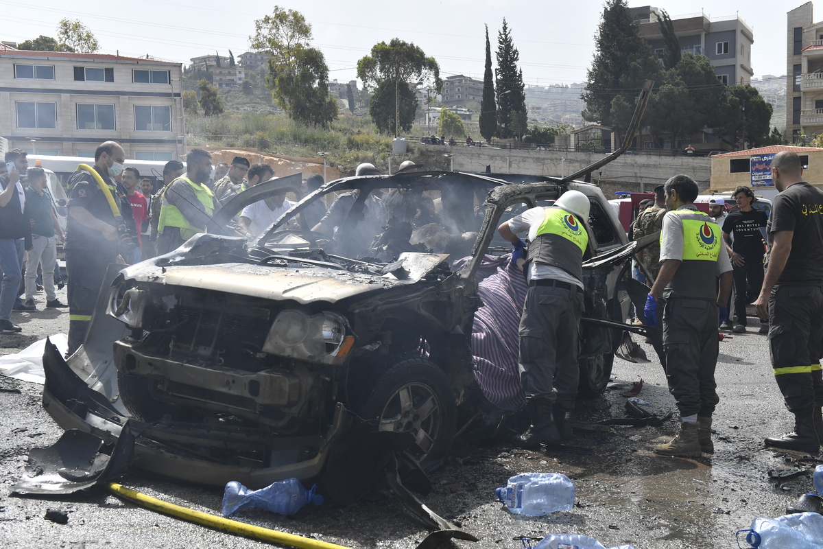 Medical teams, soldiers and civilians arrived at the scene to inspect the area after the Israeli army targeted two vehicles with drones on the coastal road despite the ceasefire in Beirut, Lebanon on May 13, 2026. [Houssam Shbaro - Anadolu Agency]