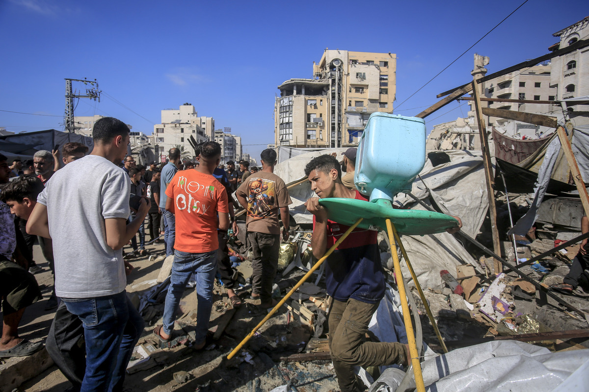 Displaced Palestinians inspect the damage after Israeli forces reportedly targeted a tent sheltering a displaced family on Jala Street on June 27, 2026, in Gaza City, Palestine. [Saeed M. M. T. Jaras - Anadolu Agency]