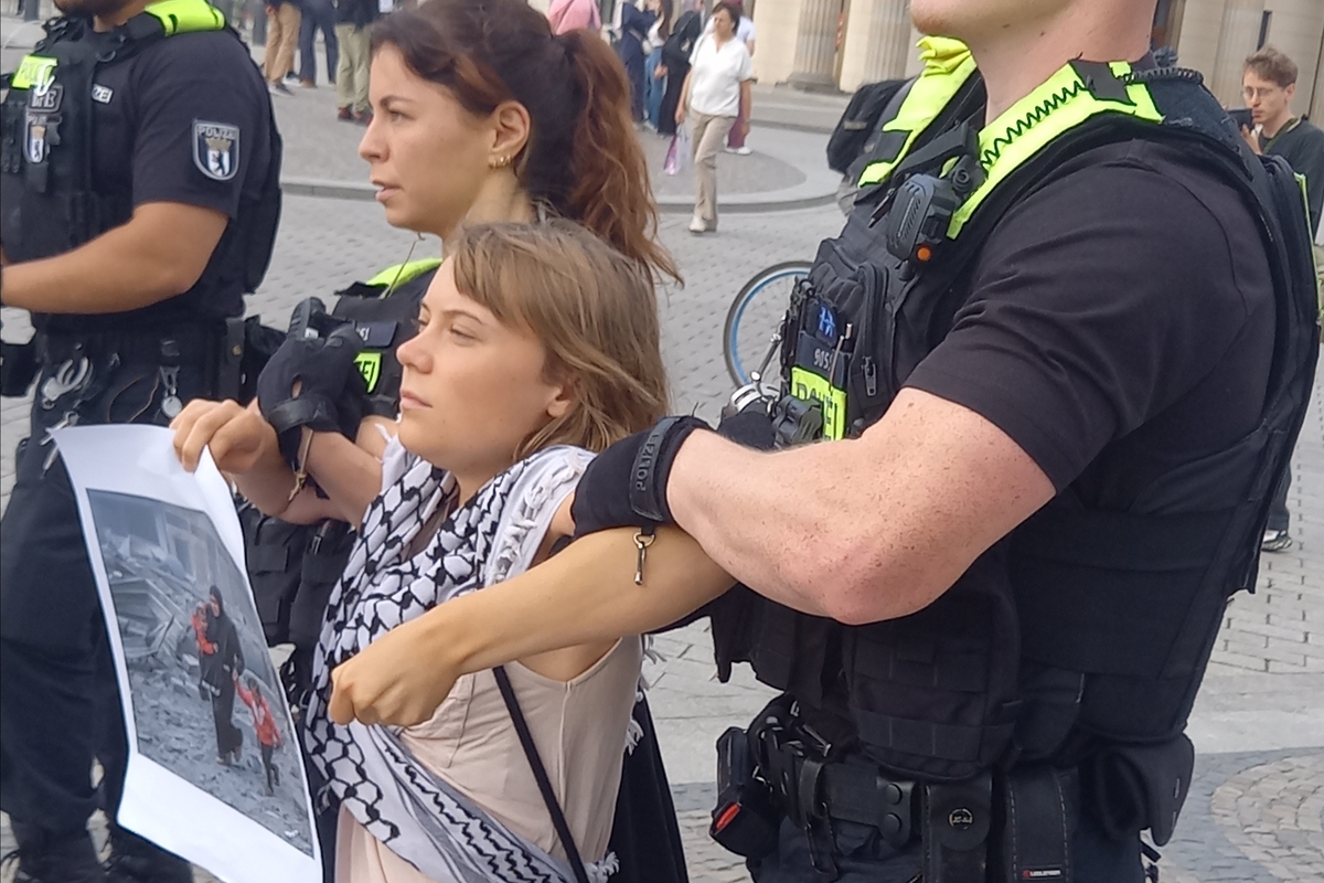 Activist Greta Thunberg is detained during "Peacefully Against Genocide" protest against the production of weapons destined for Palestine and Lebanon as people gather in front of the offices of the arms manufacturer Rheinmetall near the Brandenburg Gate in Berlin, Germany on July 13, 2026. [Peacefully Against Genocide - Anadolu Agency]