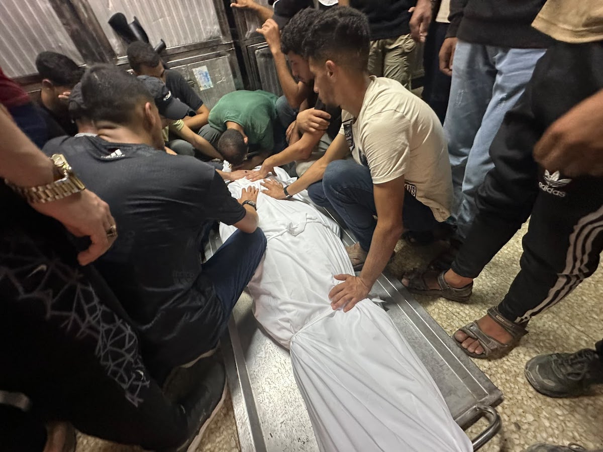 Palestinians mourn relatives killed in an Israeli strike on a police station west of the Jabalia Refugee Camp in the northern Gaza Strip in Gaza City on July 14, 2026. [Mohammed Asad/Middle East Monitor]