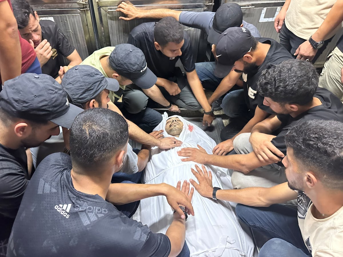 Palestinians mourn relatives killed in an Israeli strike on a police station west of the Jabalia Refugee Camp in the northern Gaza Strip in Gaza City on July 14, 2026. [Mohammed Asad/Middle East Monitor]
